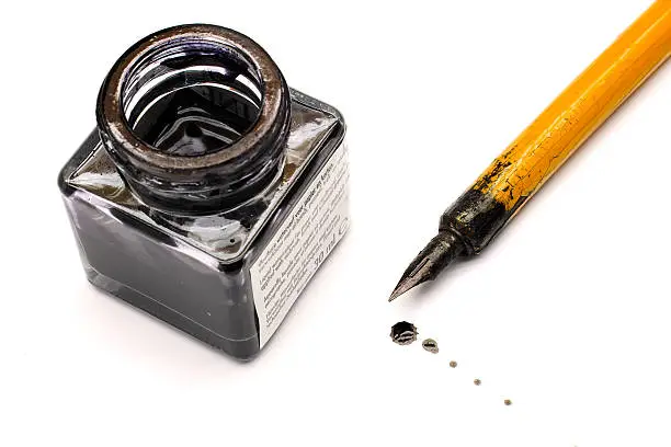 Photo of Ink bottle and nib pen