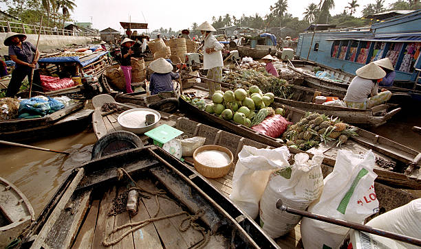 Sellers in a floating market Sellers in a floating market. Mekong Delta, Vietnam. mode of transport rowing rural scene retail stock pictures, royalty-free photos & images