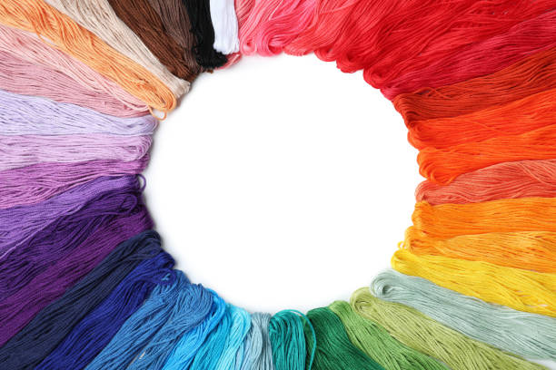 Frame of colorful embroidery threads on white background, top view