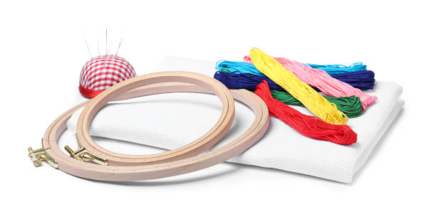 istock Colorful threads and different embroidery accessories on white background 1443347835