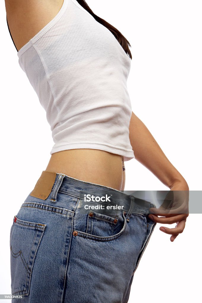 A young woman holding bigger fitted pants view of female became skinny  and wearing old jeans  Dieting Stock Photo