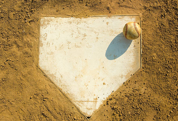 Baseball on Home Baseball on top of home plate - great for sports background etc. home plate stock pictures, royalty-free photos & images