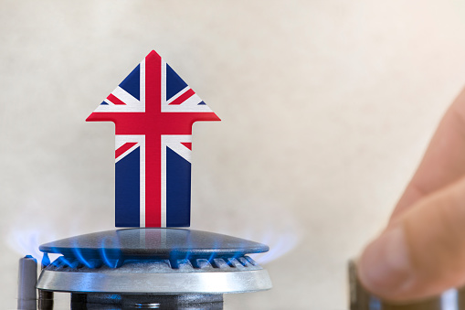 Gas price. Rise in gas prices in United Kingdom. A burner with a flame and an arrow up, painted in the colors of the United Kingdom flag. The concept of rising gas or energy prices