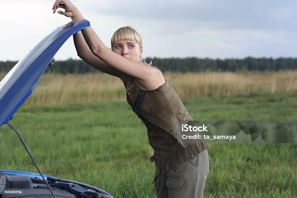 Mujer joven con su coche roto - Foto de stock de Accidente de automóvil libre de derechos