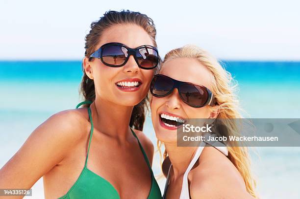 Closeup Of Two Young Women Smiling On The Beach Stock Photo - Download Image Now - Beach, Human Face, Sensuality