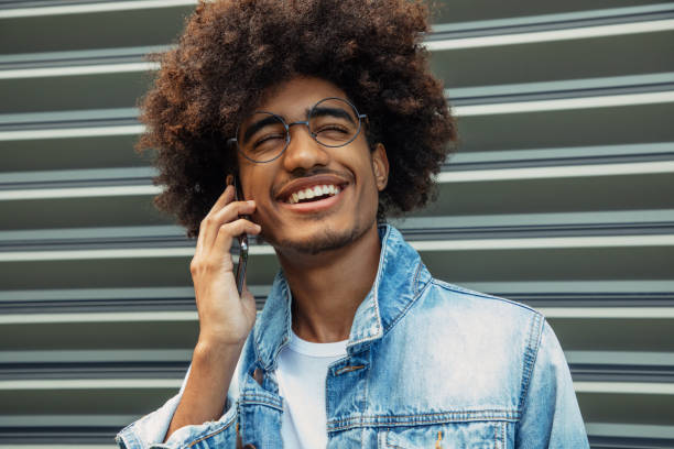 istock African american man with african hairstyle using phone 1443351868