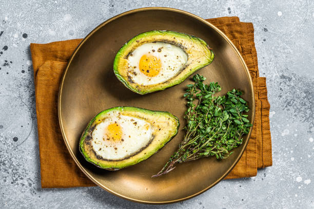 istock Brunch with Baked Avocado and Egg. Gray background. Top view 1443352801