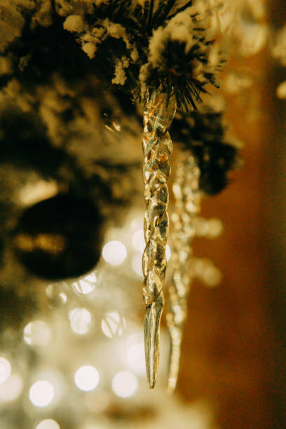 istock Icicles hanging on a Christmas tree close-up. A decor concept for decorating a house for the New Year holidays. 1443354041