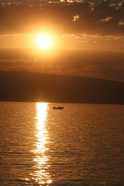 istock Sunset on the sea with a boat 144335618