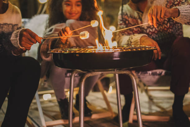 Family on porch making roasted marshmallow