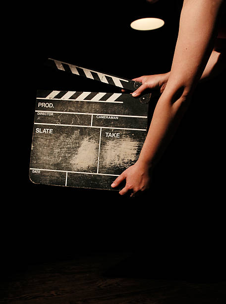 istock Hands holding a movie clapper board on black background 144336133