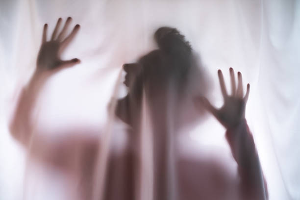 istock Depressed Man with mantal problems hiding above the curtain. 1443364983