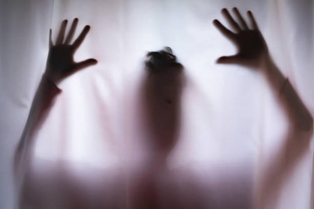 istock Depressed Man with mantal problems hiding above the curtain. 1443365407