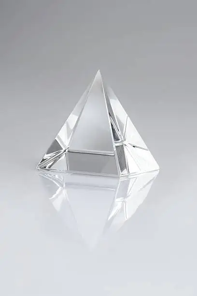 crystal pyramid on gray gradient background