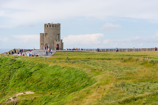 Cliffs of Moher, Ireland - July 7, 2007: Tourists visiting O'Brien's Tower at The Cliffs of Moher in Ireland
