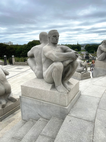 August 28, 2022 - Oslo, Norway.  Visitors to the city enjoy walking through the sculpture park which is Gustav Vigeland's life work, comprising over 200 sculptures in granite, bronze and wrought iron.