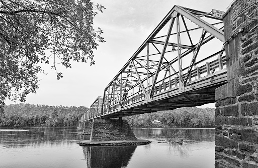 The Uhlerstown-Frenchtown Bridge from Frenchtown, New Jersey to Uherlstown, Pennsylvania. The bridge crosses the Delaware River. The photo is in black and white.