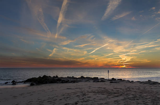 sonnenuntergang am cape may point new jersey shore - vapor trail sky night sunset stock-fotos und bilder