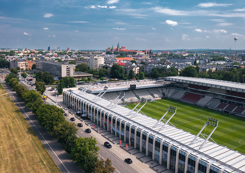 Kraków, Poland - July 2022: Cityscape of the Old Town and Cracovia Stadium (Stadion Cracovii im. Józefa Piłsudskiego), home ground for MKS Cracovia football club
