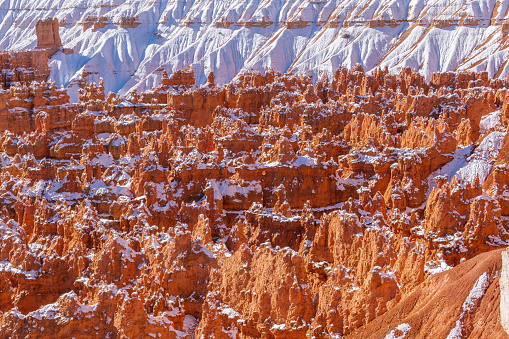 Late Autumn in Bryce Canyon National Park in Utah. A light snow covers the ground and rests on top of the hoodoos in the canyon.