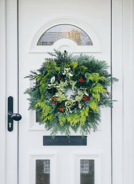 istock Handmade fresh foraged winter wreath hanging on the front door 1443375134