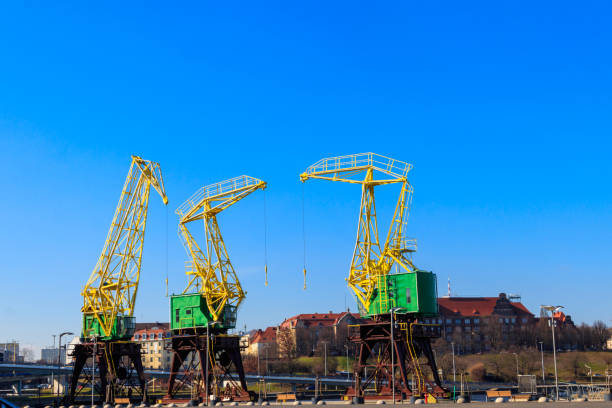 istock Old cranes on city boulevard in Szczecin, Poland 1443376449