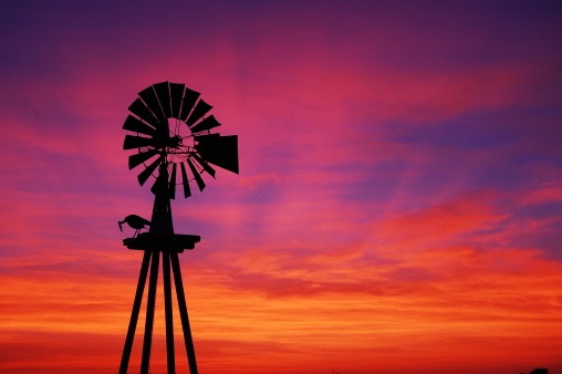 Windmill silhouette on a farm in Texas.