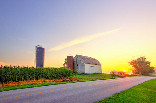 Farm Sunrise with barn-silo and country road-Howard County, Indiana stock photo
