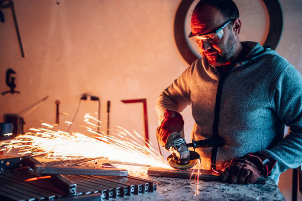 istock Worker in a factory grinding metal with a grinder 1443381591