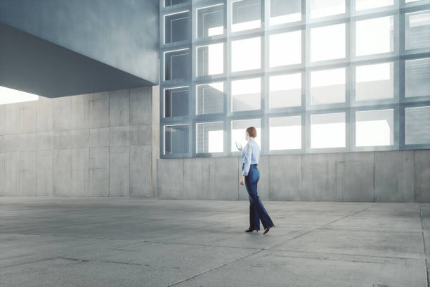 istock Woman walking modern office building lobby 1443383983