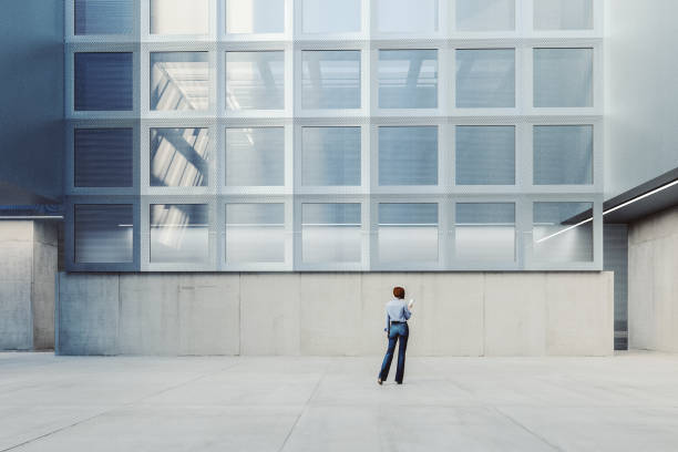istock Woman walking modern office building lobby 1443383991