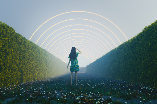 Woman standing in fantasy hedge maze. 3D generated image.