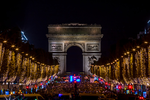 Paris, France - November 20, 2022: Christmas time, the decoration along the Avenue des Champs Elysees with Arc de Triomphe in background in Paris, France