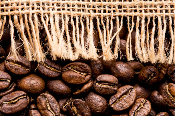 istock Roasted coffee beans, on sackcloth, closeup image, space for text 1443385846