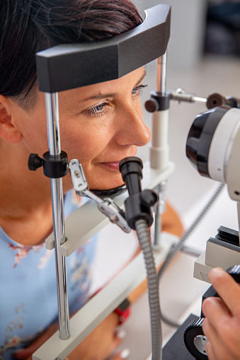 Woman having the Iridology exam to determine information about a her systemic health