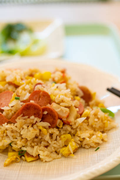 istock angle view fried rice with crab sticks and sausages and maizes vertical composition 1443386759