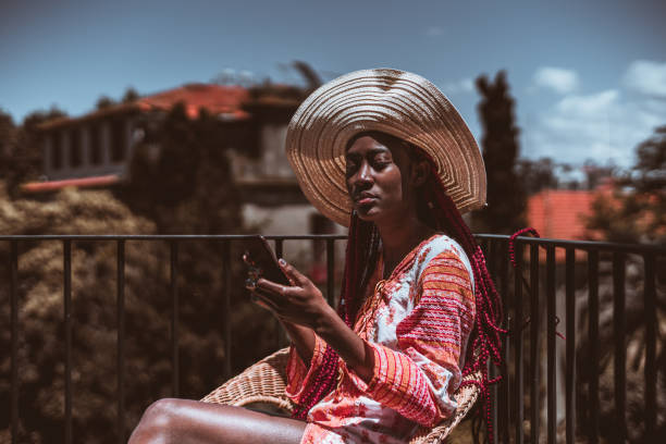 black girl in dress using cellphone - braids african descent women pensive imagens e fotografias de stock