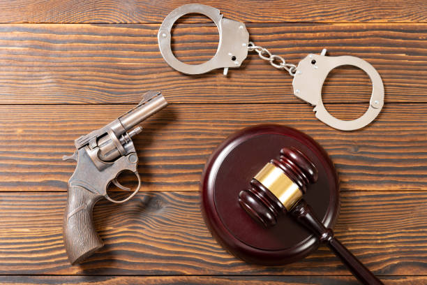 istock top view gavel and gun and handcuffs 1443387751