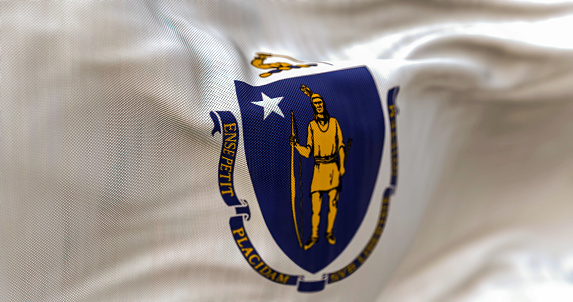 Close up view of the Massachusetts state flag waving. Massachusetts is a state in the New England region of the US. Fabric textured background. Selective focus. 3D illustration
