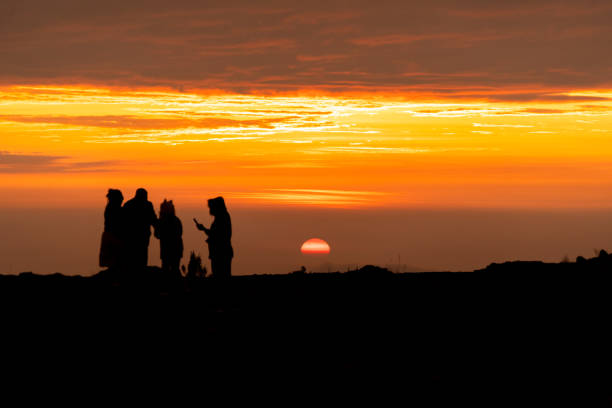 istock Group of people in a sunset, sunset silhouette 1443389526
