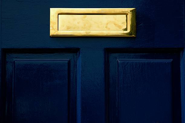 istock A gold letter box on a blue door 144339459