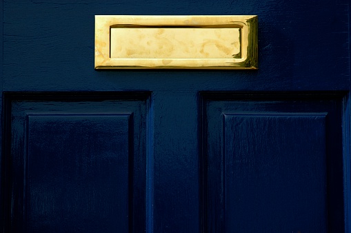 Gold letter box in blue gloss painted door