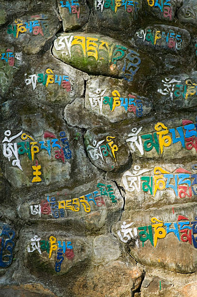 Tibetian script on stones stock photo