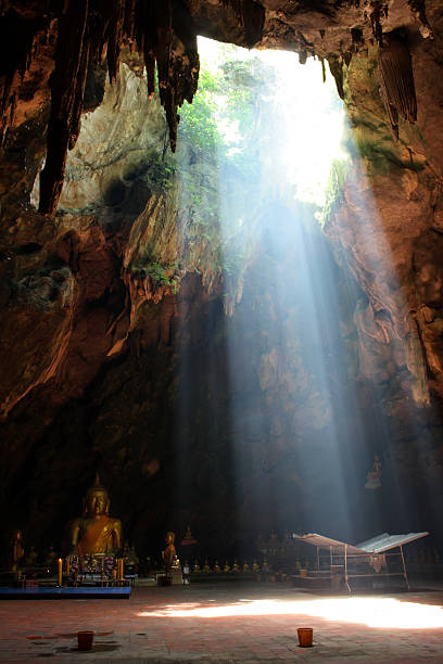 istock Ray of sunlight breaking into Tham Khao Luang Cave 144339881