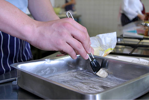 Buttering up a pan stock photo