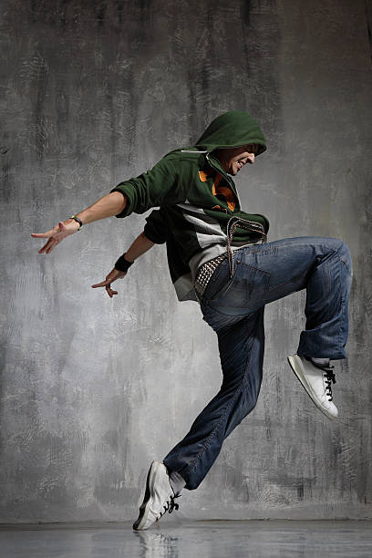 istock Man wearing hoodie dancing against gray background 144340027