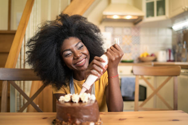 istock A woman is decorating a birthday cake 1443403181
