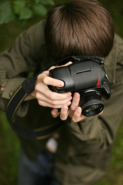 istock Young photographer with DSLR 144340751