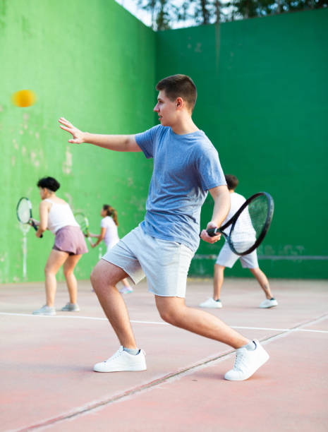 istock Young man playing frontenis at open-air fronton court in summer 1443408349