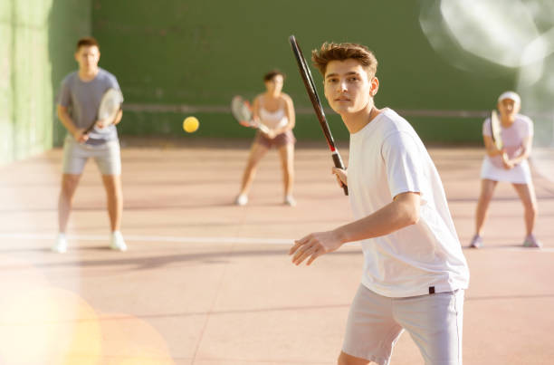 istock Guy hits the ball with a racket while playing frontenis on outdoor court 1443408412